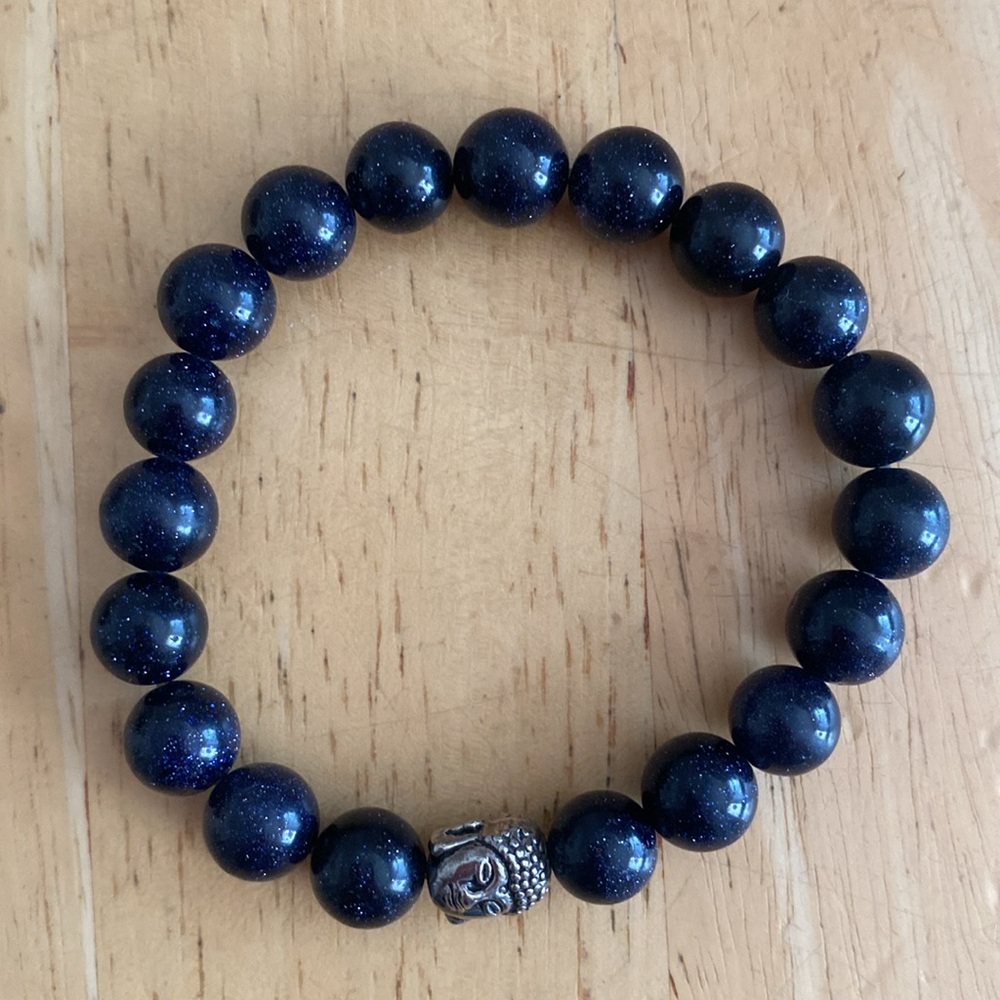 Dark blue sandstone and Buddha beaded stretch bracelet.